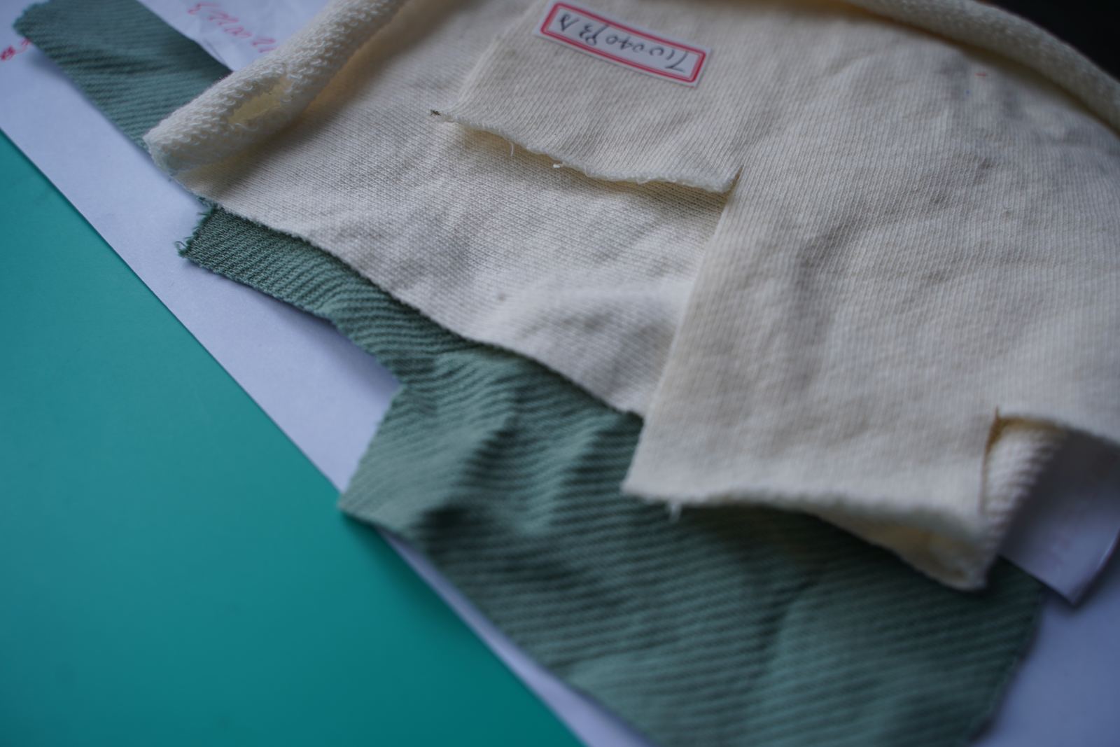 Knit and twill fabric swatches laid out for review