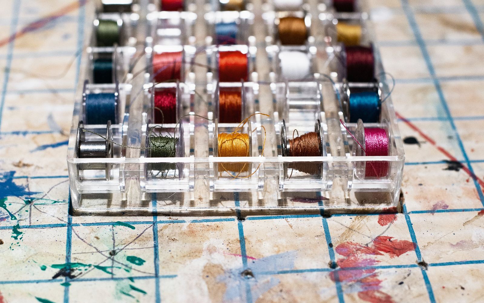 Rows of bobbins wound with colorful threads